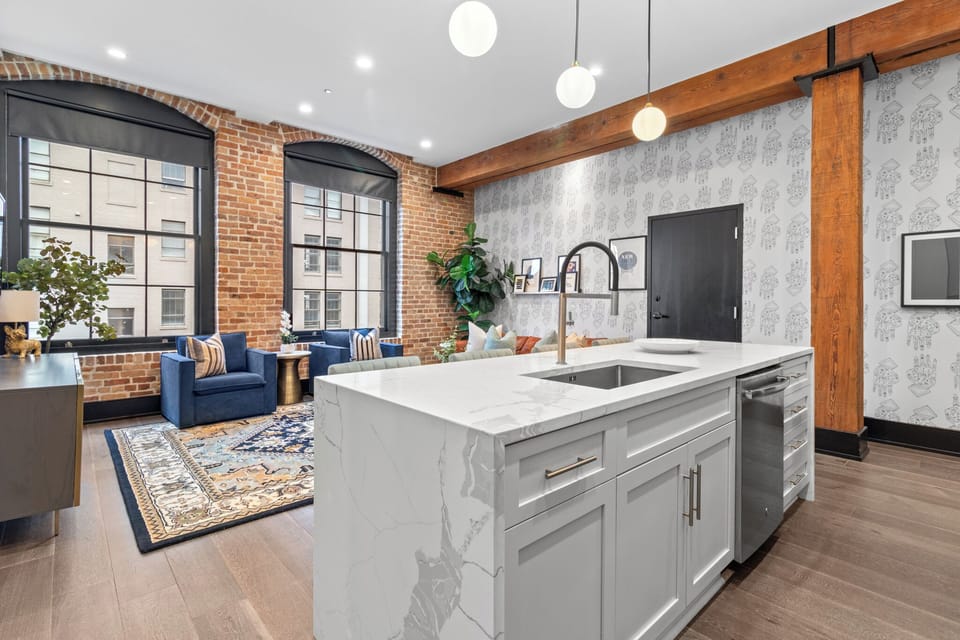 Cook or snack in style with a full kitchen featuring GE stainless appliances, cookware, and an island with bar seating. Ideal for short or extended stays, our kitchens make group travel in New Orleans easy and comfortable.