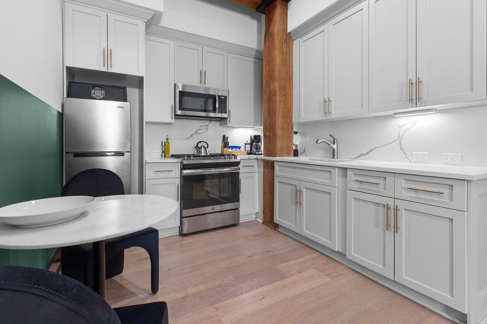 Cook or snack in style with a full kitchen featuring GE stainless appliances, cookware, and an island with bar seating. Ideal for short or extended stays, our kitchens make group travel in New Orleans easy and comfortable.