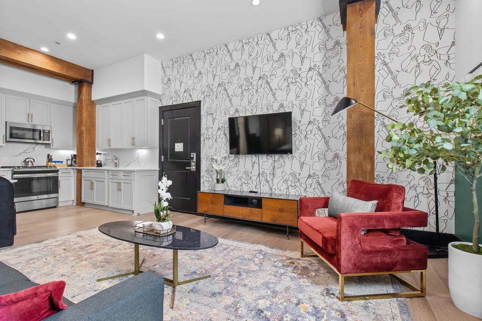 Relax in the studio living area with a smart TV, stylish seating, king-sized bed and a futon for extra guest. This inviting space is ideal for movie nights or recharging after a day in the city.