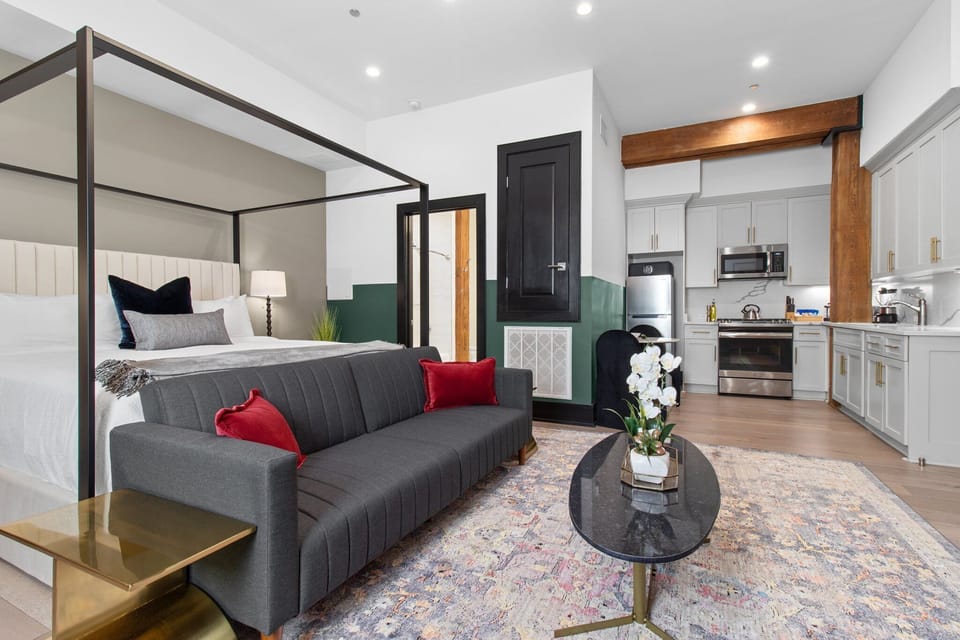 Relax in the studio living area with a smart TV, stylish seating, king-sized bed and a futon for extra guest. This inviting space is ideal for movie nights or recharging after a day in the city.