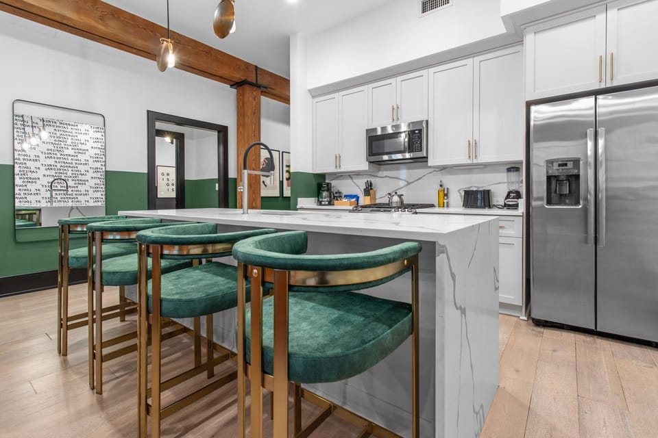 Cook or snack in style with a full kitchen featuring GE stainless appliances, cookware, and an island with bar seating. Ideal for short or extended stays, our kitchens make group travel in New Orleans easy and comfortable.