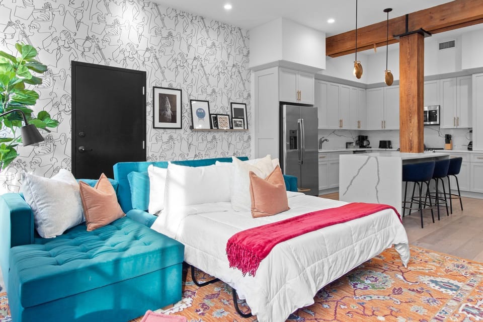 Relax in the living area with a smart TV, stylish seating, and a sleeper sofa for extra guests. Perfect for families or group stays in New Orleans, this inviting space is ideal for movie nights or recharging after a day in the city.