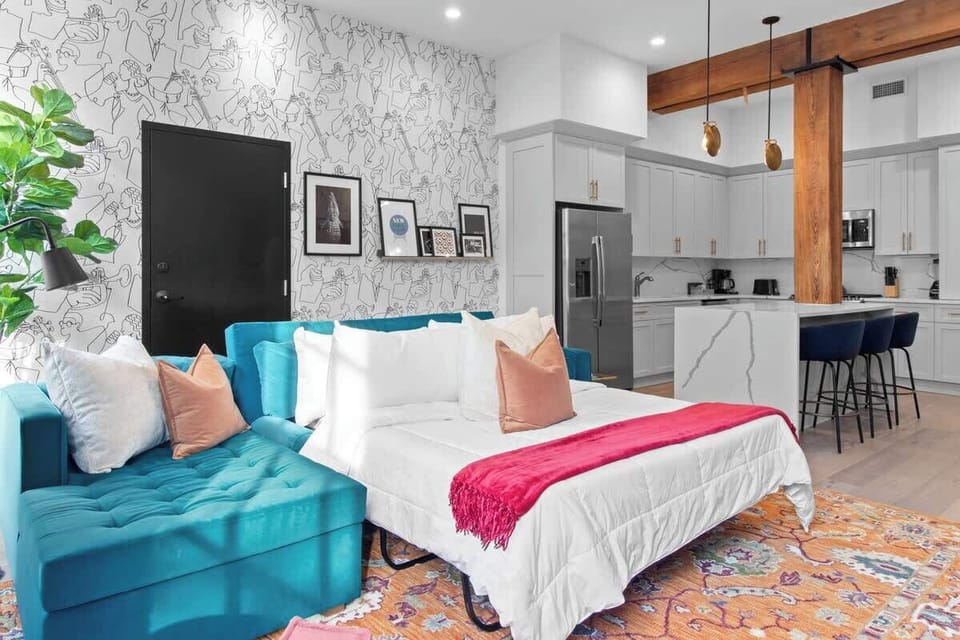 Relax in the living area with a smart TV, stylish seating, and a sleeper sofa for extra guests. Perfect for families or group stays in New Orleans, this inviting space is ideal for movie nights or recharging after a day in the city.