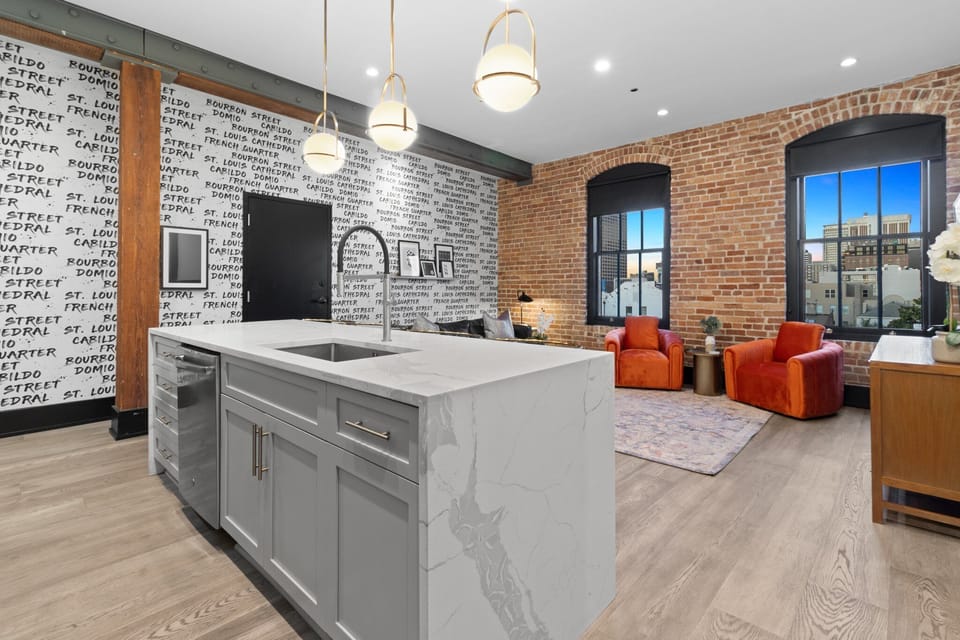Cook or snack in style with a full kitchen featuring GE stainless appliances, cookware, and an island with bar seating. Ideal for short or extended stays, our kitchens make group travel in New Orleans easy and comfortable.