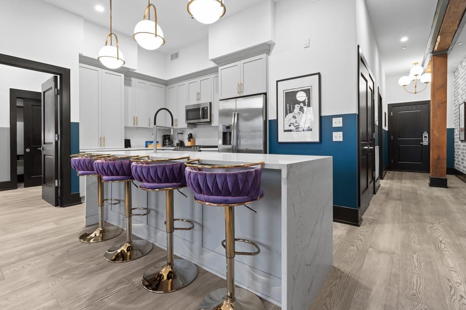 Cook or snack in style with a full kitchen featuring GE stainless appliances, cookware, and an island with bar seating. Ideal for short or extended stays, our kitchens make group travel in New Orleans easy and comfortable.