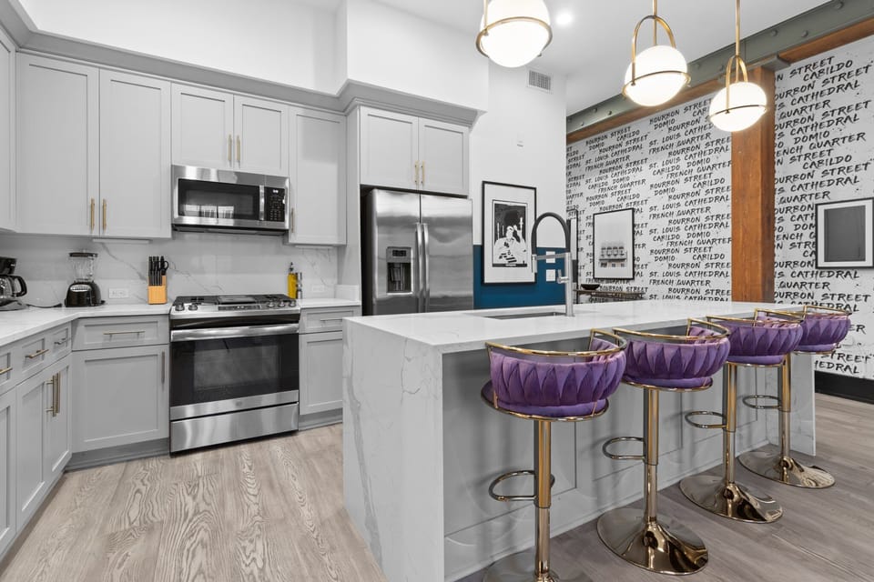 Cook or snack in style with a full kitchen featuring GE stainless appliances, cookware, and an island with bar seating. Ideal for short or extended stays, our kitchens make group travel in New Orleans easy and comfortable.