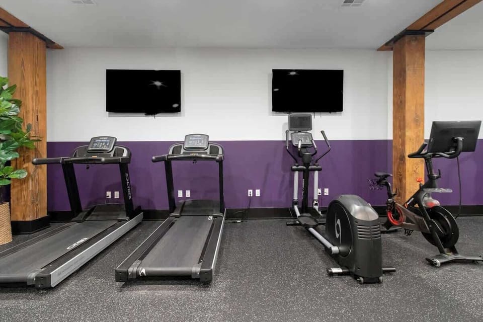 Stay fit at 888 Baronne Street with a fully equipped gym featuring Cybex machines, TRX bands, Peloton, cardio gear, free weights, smart TVs, and a filtered water station—all in a clean, modern space.