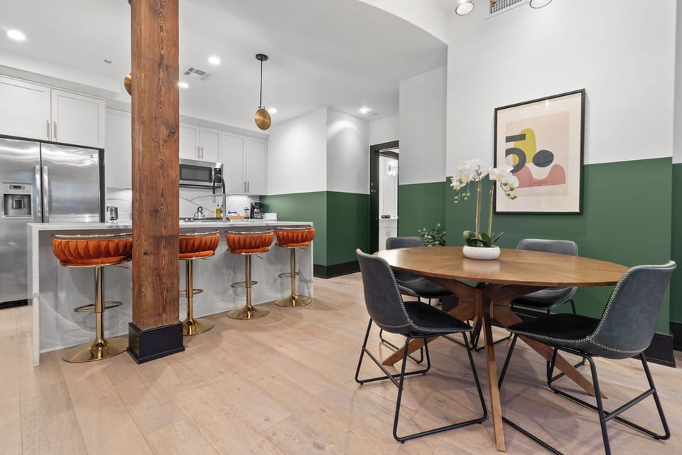 Enjoy meals together at your in-suite dining table with seating for your group. Whether it's takeout, delivery, or a home-cooked meal, this cozy dining area makes every stay at 888 Baronne feel like home in New Orleans.