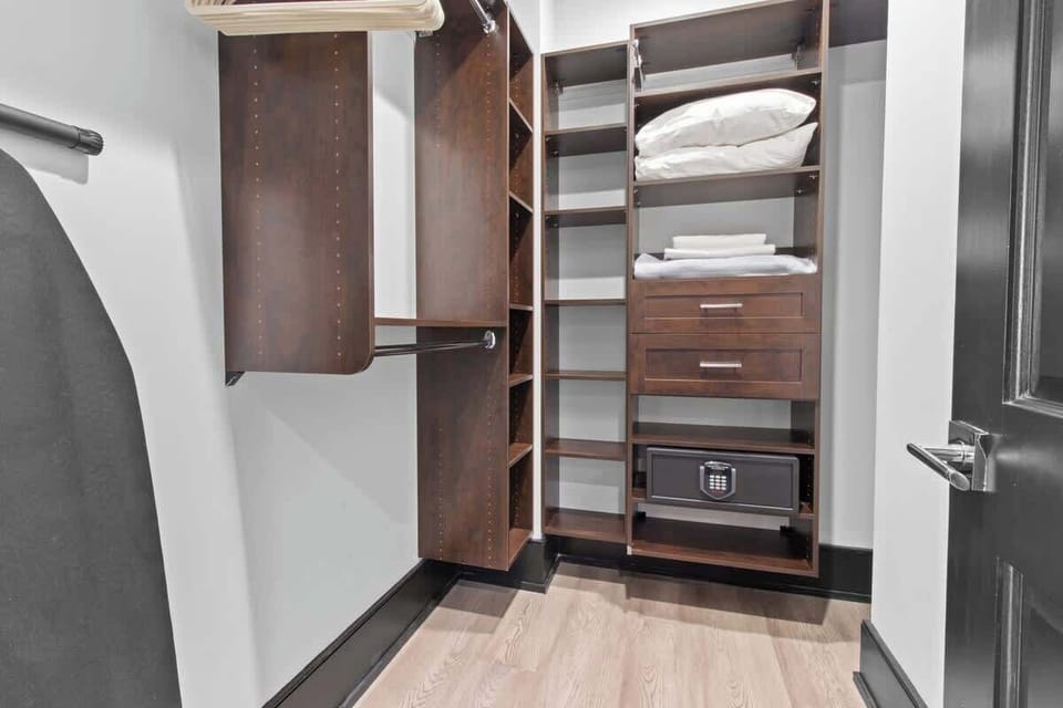 The primary bathroom offers sleek finishes, a soaking tub with Smart TV, walk-in shower, and plush towels. Spacious and private, it adds a luxurious touch to your suite—perfect for unwinding after a day in Downtown New Orleans.