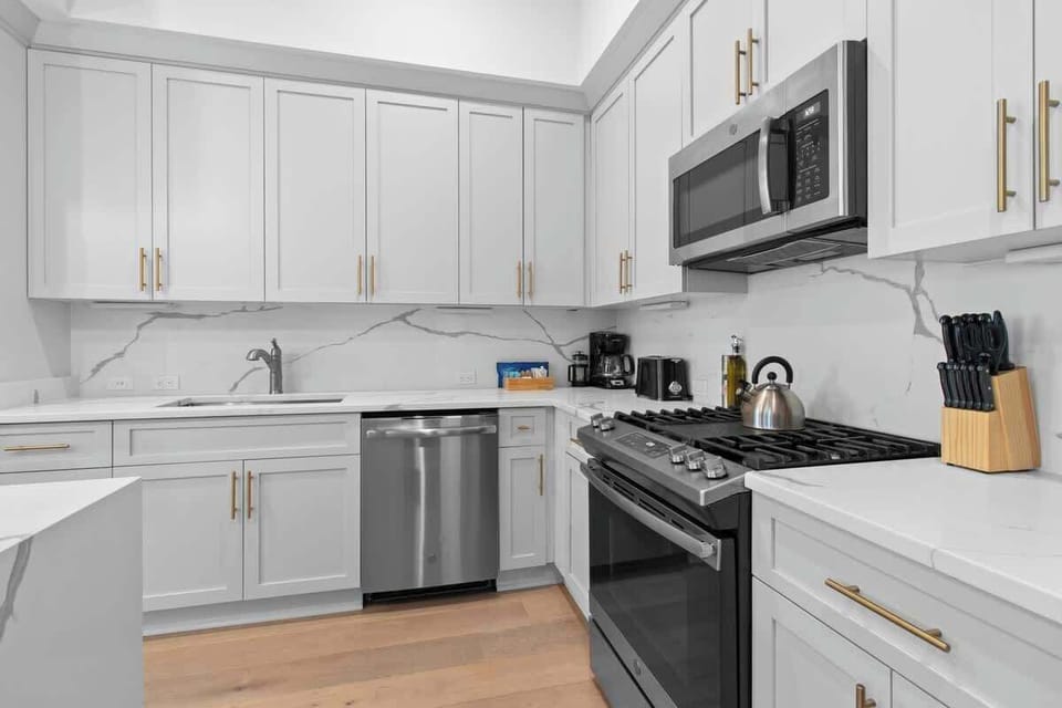 Cook or snack in style with a full kitchen featuring GE stainless appliances, cookware, and an island with bar seating. Ideal for short or extended stays, our kitchens make group travel in New Orleans easy and comfortable.