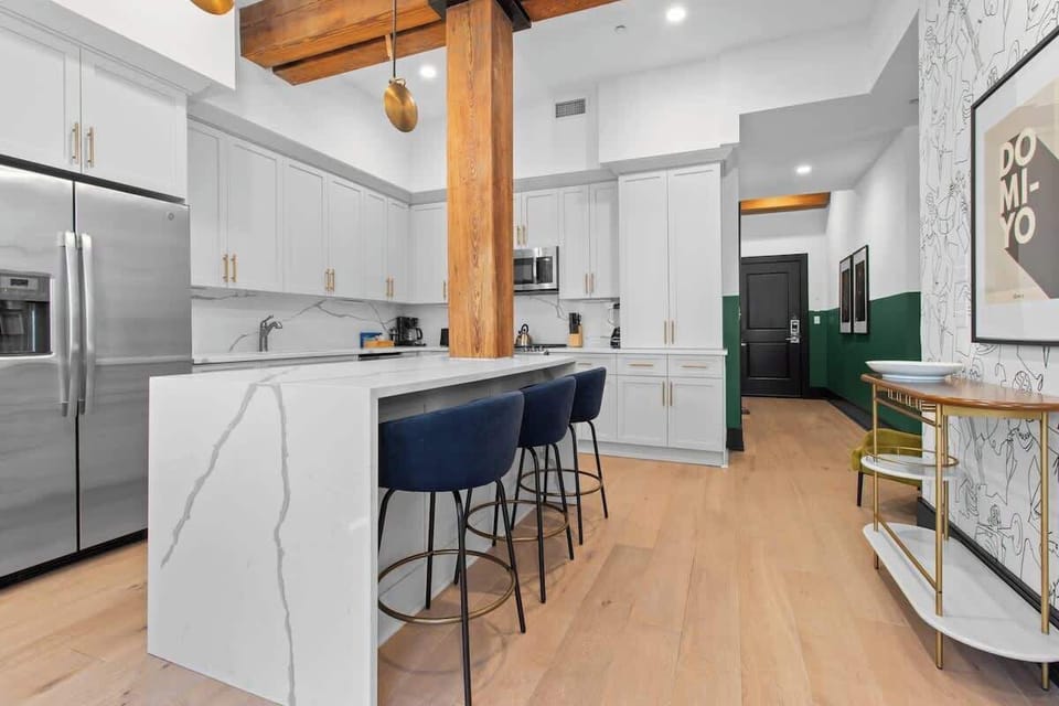 Cook or snack in style with a full kitchen featuring GE stainless appliances, cookware, and an island with bar seating. Ideal for short or extended stays, our kitchens make group travel in New Orleans easy and comfortable.