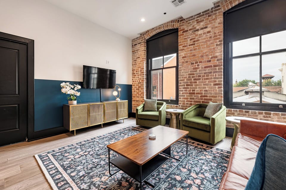 Relax in the living area with a smart TV, stylish seating, and a sleeper sofa for extra guests. Perfect for families or group stays in New Orleans, this inviting space is ideal for movie nights or recharging after a day in the city.