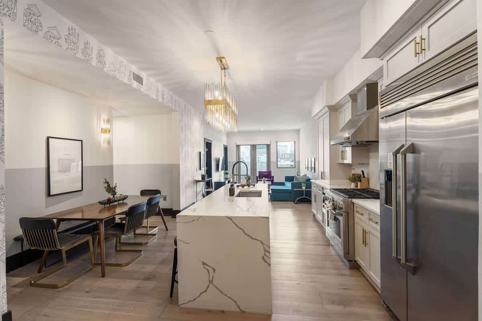 Cook or snack in style with a full kitchen featuring GE stainless appliances, cookware, and an island with bar seating. Ideal for short or extended stays, our kitchens make group travel in New Orleans easy and comfortable.