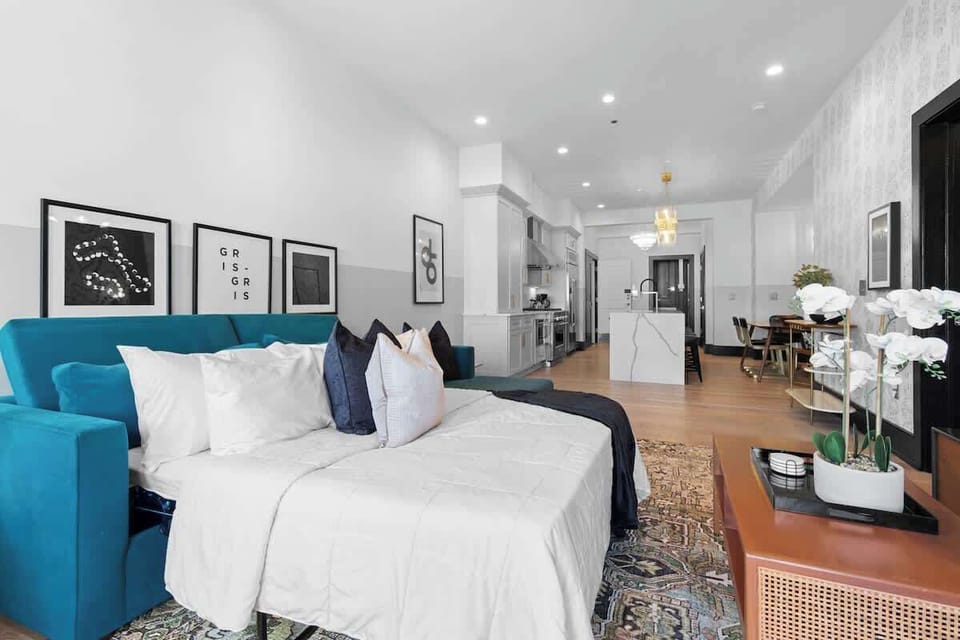 Relax in the living area with a smart TV, stylish seating, and a sleeper sofa for extra guests. Perfect for families or group stays in New Orleans, this inviting space is ideal for movie nights or recharging after a day in the city.