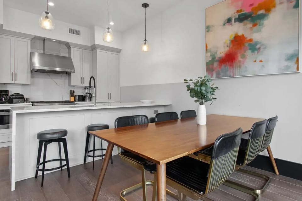 Enjoy meals together at your in-suite dining table with seating for your group. Whether it's takeout, delivery, or a home-cooked meal, this cozy dining area makes every stay at 888 Baronne feel like home in New Orleans.