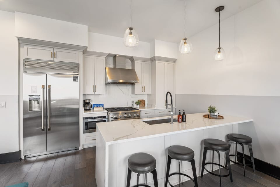 Cook or snack in style with a full kitchen featuring GE stainless appliances, cookware, and an island with bar seating. Ideal for short or extended stays, our kitchens make group travel in New Orleans easy and comfortable.