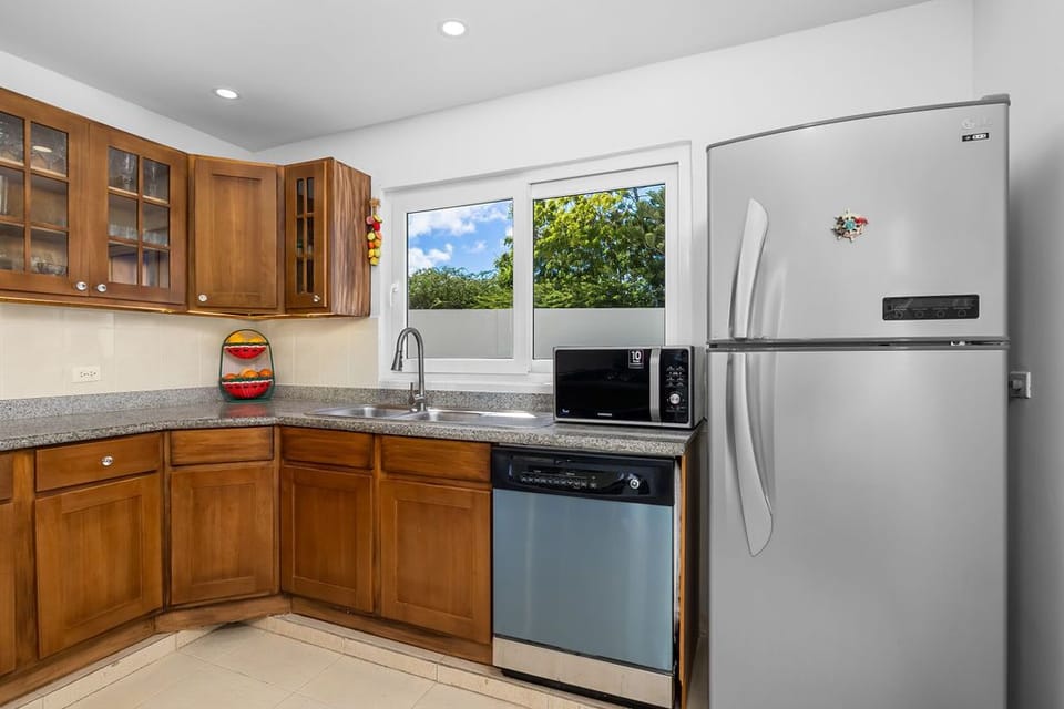 Fully equipped kitchen with microwave, refrigerator, and dishwasher.