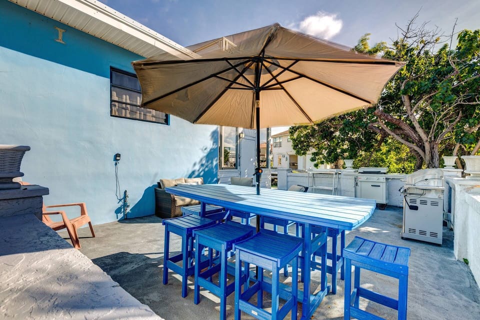 Enjoy outdoor dining with a fully equipped grill & flat top griddle, a spacious table, and chairs, perfect for relaxing meals and entertaining guests.