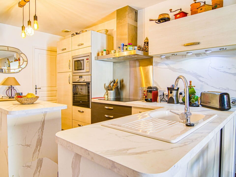 Cabinetry, Table, Countertop, Property, Furniture, Kitchen, Interior Design, Orange, Lighting, Home Appliance