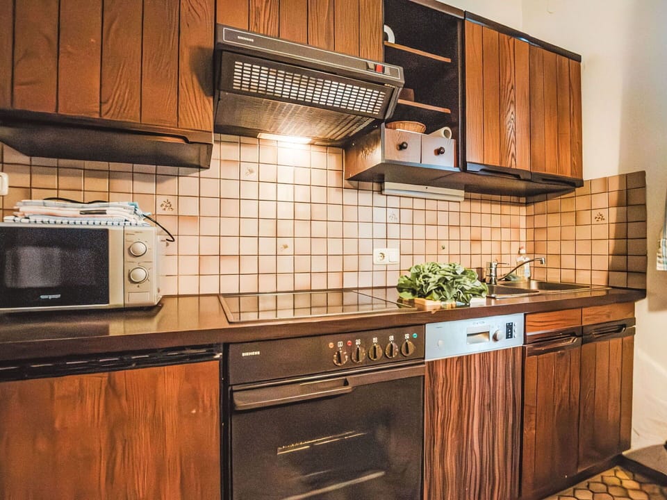 Wood, Kitchen, Interior Design, Flooring, Brown, Countertop, Kitchen Stove, Cabinetry, Kitchen Appliance, Wood Stain