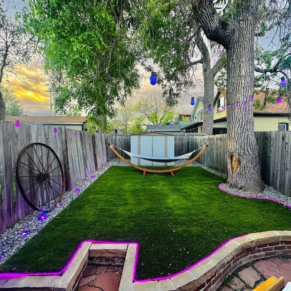 Private Backyard Oasis with Fire Pit, Seating, and Grass Area