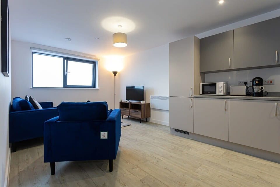 Unwind on the plush blue sofas in your open plan living and dining space after a day in the city