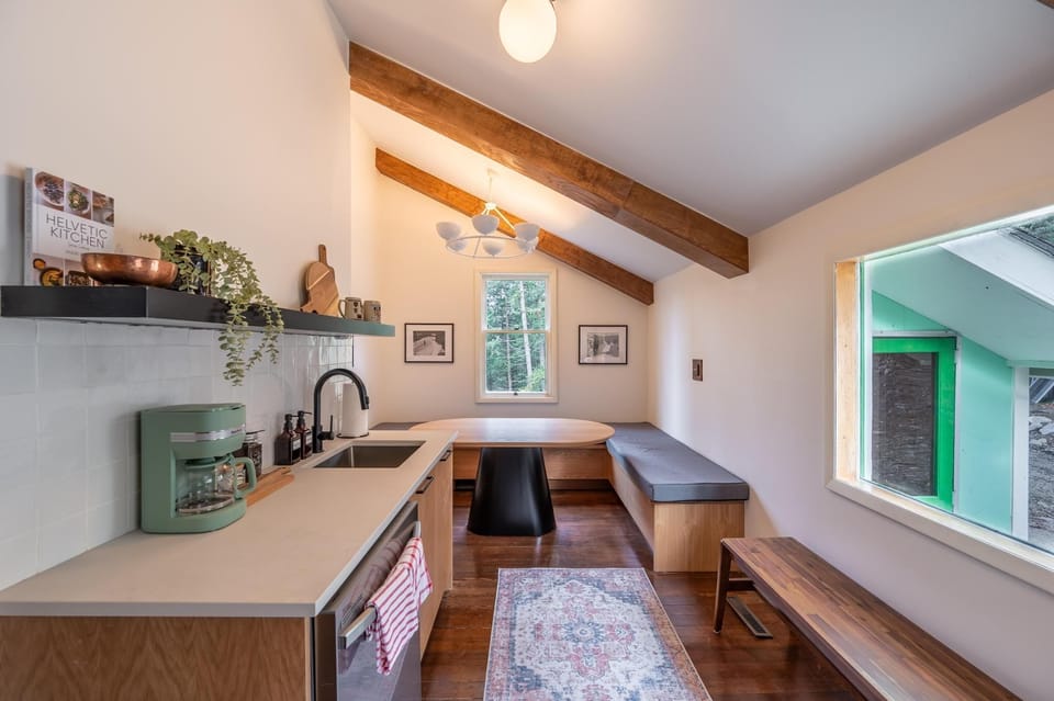 Enjoy cozy dining in a space adorned with warm wooden beams and inviting natural light.