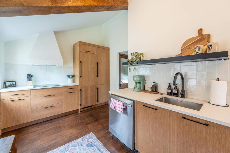 This inviting kitchen blends modern charm with classic touches, perfect for brewing your morning coffee.