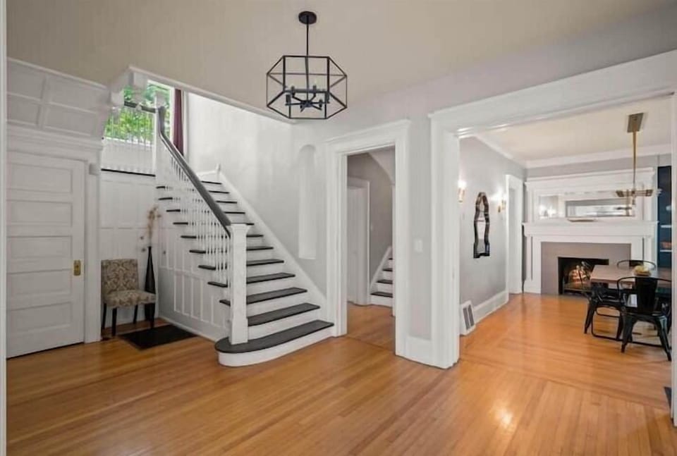 Bright and airy entryway with grand staircase, and high ceilings