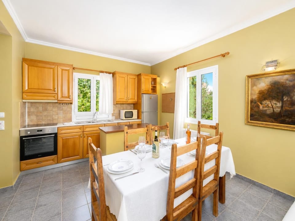 Open-plan living room with sofas, dining area, kitchen, ornamental fireplace, A/C, WiFi internet, satellite TV, and sea views