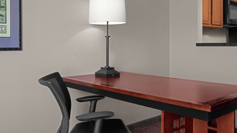 Focus comfortably at the dedicated desk with warm task lighting.
