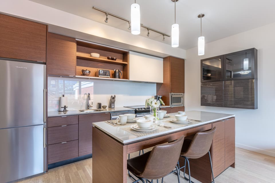 Another clean perspective of the kitchen, showcasing the premium stainless steel appliances and contemporary flat-panel cabinetry.