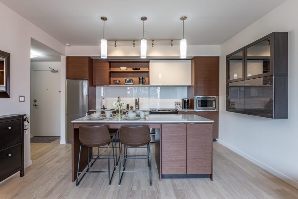 Channel your inner chef in the premium, fully equipped kitchen featuring a massive central island with a wood-accent breakfast bar.
