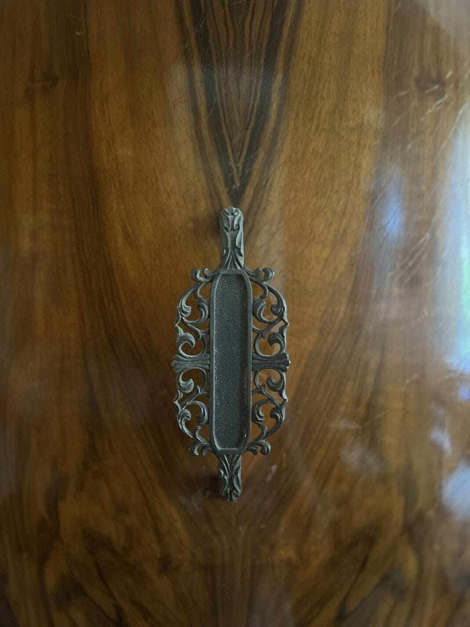 Details: Door pull on vintage chifferobe in bedroom.