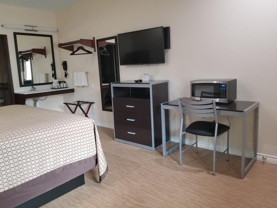 Unwind after adventure with TV, desk, and cozy bed.