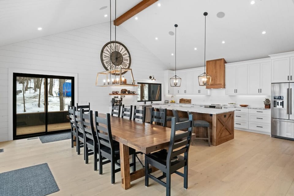 Dining area with large wood table for sitting 10 or more people.