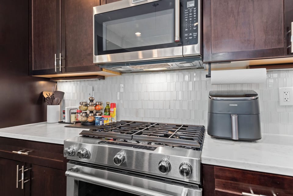 Stainless steel gas range, built-in microwave, and many other kitchen essentials