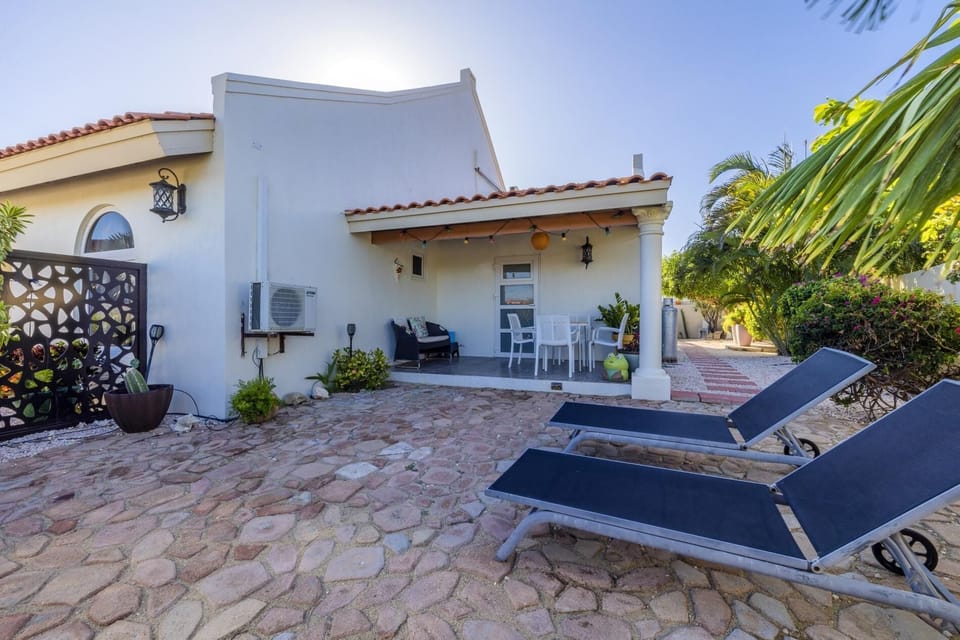 Inviting outdoor sitting space with lush surroundings and comfy seats.