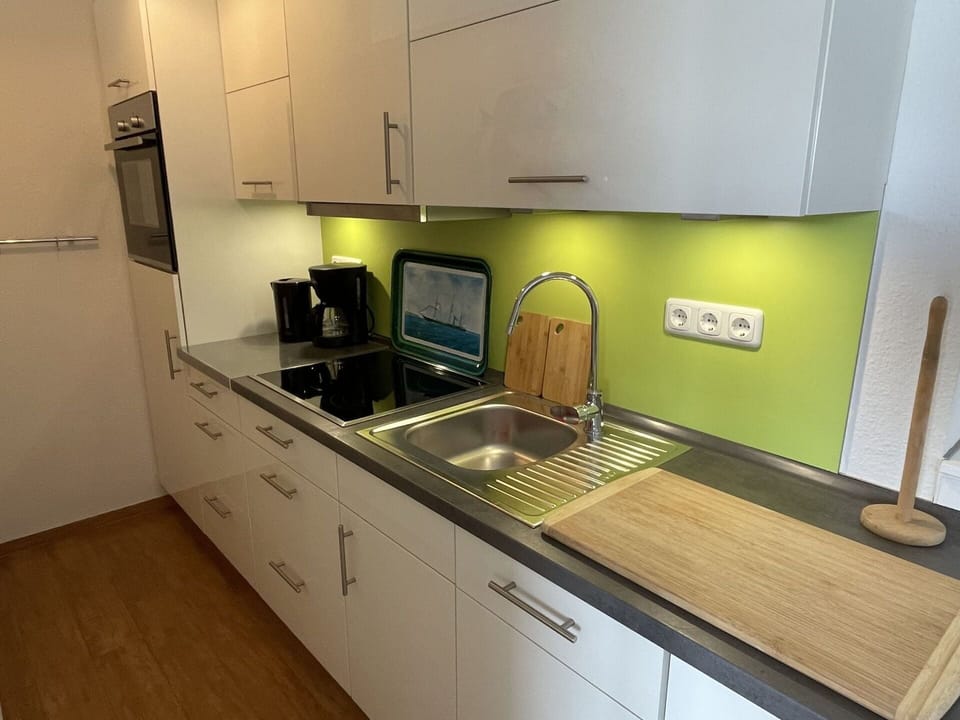 Tap, Cabinetry, Kitchen Sink, Countertop, Sink, Plumbing Fixture, Kitchen Appliance, Kitchen Stove, Lighting, Kitchen