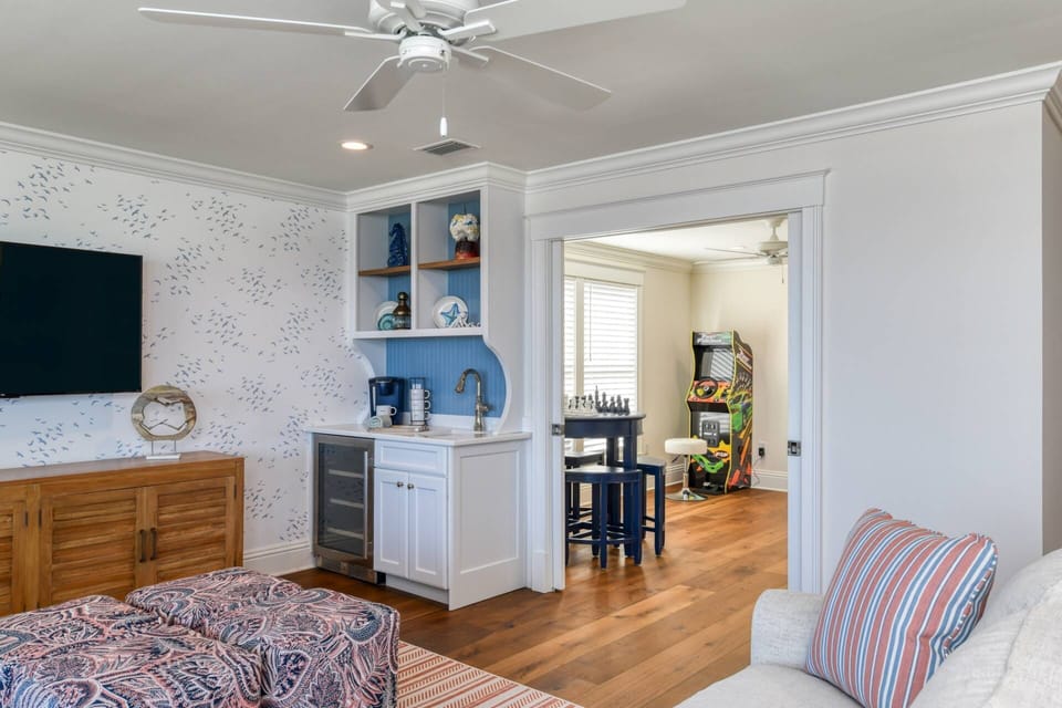 The second living room features a large tv and wet bar! Just through these double doors you'll find endless opportunities for fun in the arcade!