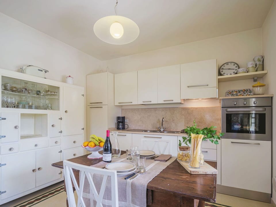 Cabinetry, Countertop, Property, Kitchen, Kitchen Appliance, Kitchen Stove, Wood, Interior Design, Lighting, Home Appliance
