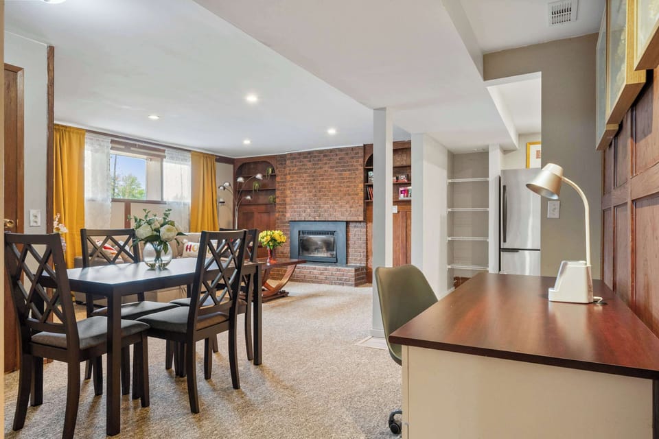 Private basement suite with a fireplace, dining area, and a workspace with a desk for your comfort.