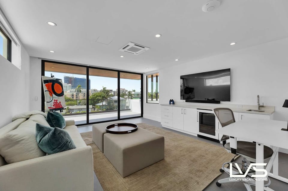 DEN (Water & Pool Views / 3rd Floor) - Queen Sofa Pullout  - Smart TV - Coffee Table  - Computer Table & Swivel Chair  - Wet Bar with fridge & sink.