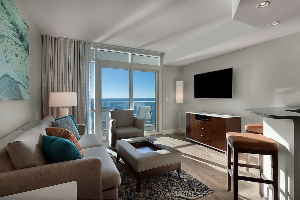 Unwind on the sofa as sunlight pours in from the balcony.