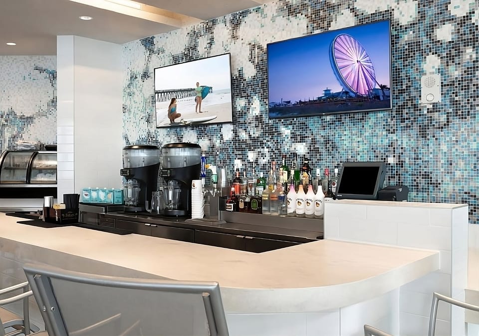 Enjoy a polished bar setup with curated spirits and screens.