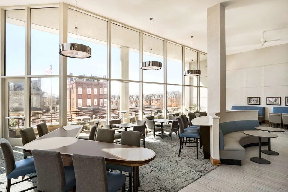 Wake up to sunlit seating and lively neighborhood views.