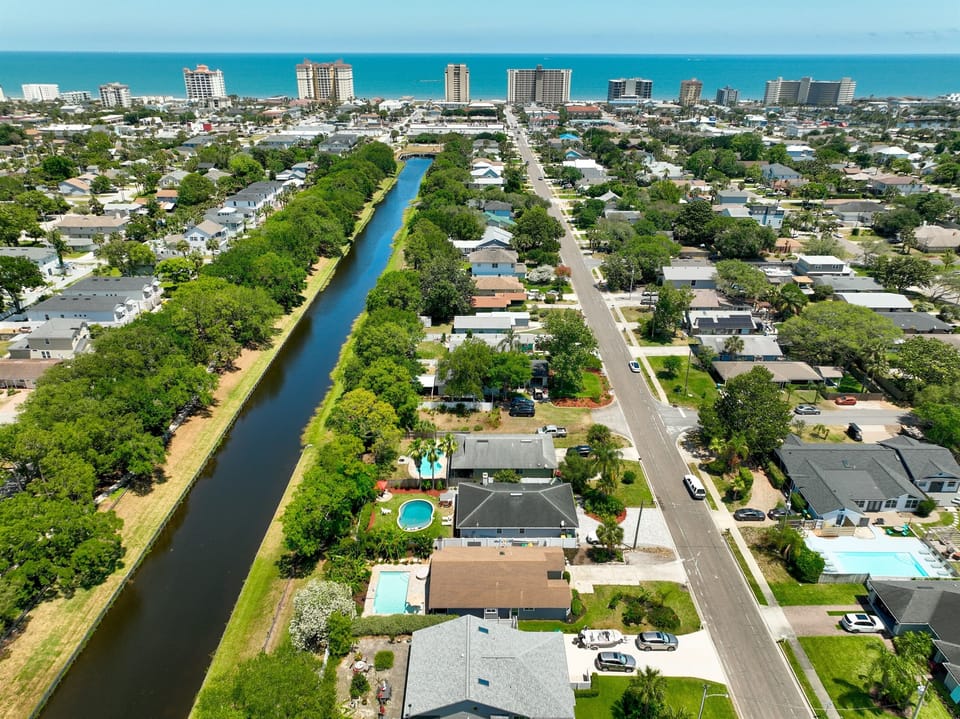 The home is located on a canal with a walking path to parks and the beaches.
