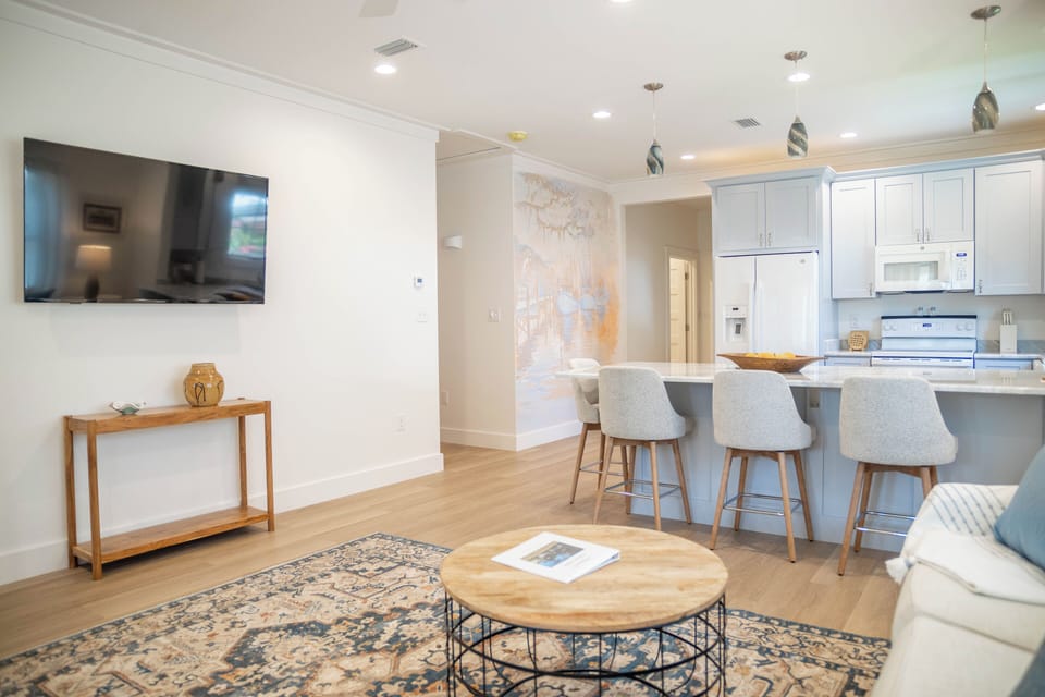Open floorplan kitchen and living room with large Smart TV for streaming 