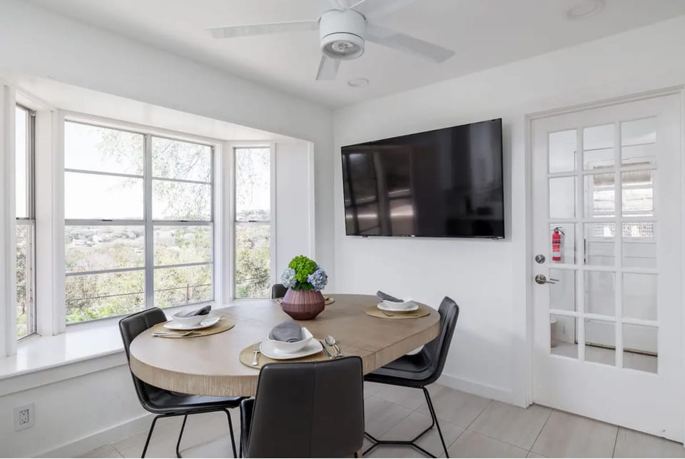 Breakfast/dining area adjacent to kitchen with 70 inch smart TV 