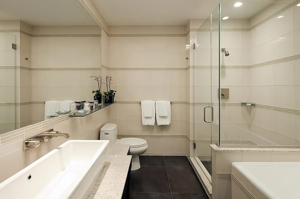 Enjoy a spotless bath space with shower and soft towels.